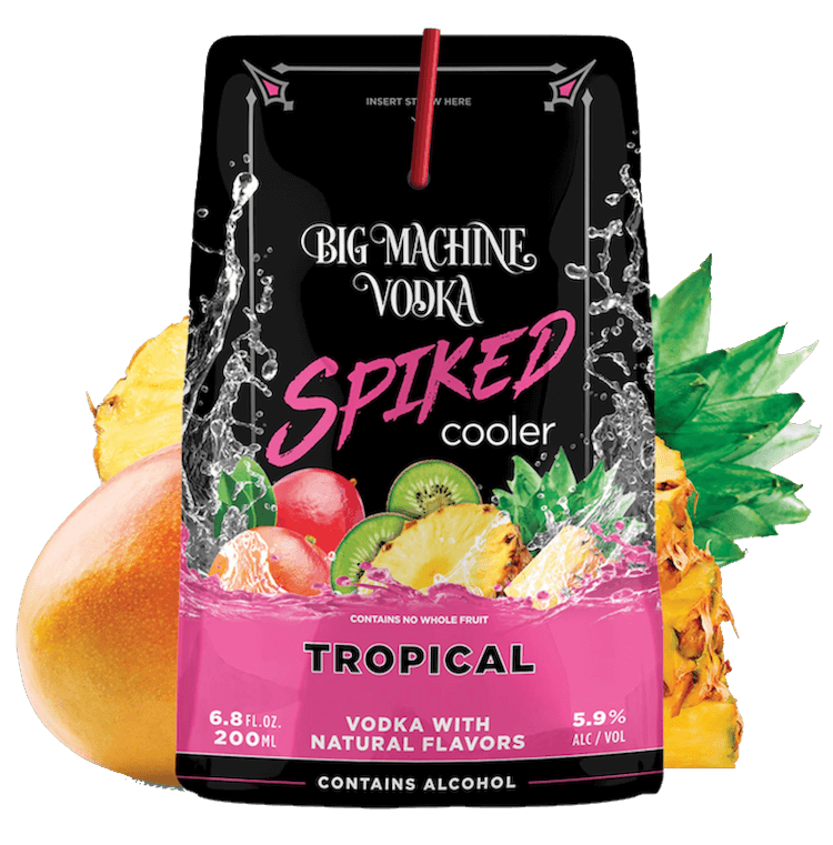 Woman in black long-sleeve leotard and sheer black skirt posing with arms raised and one foot crossed barefoot.