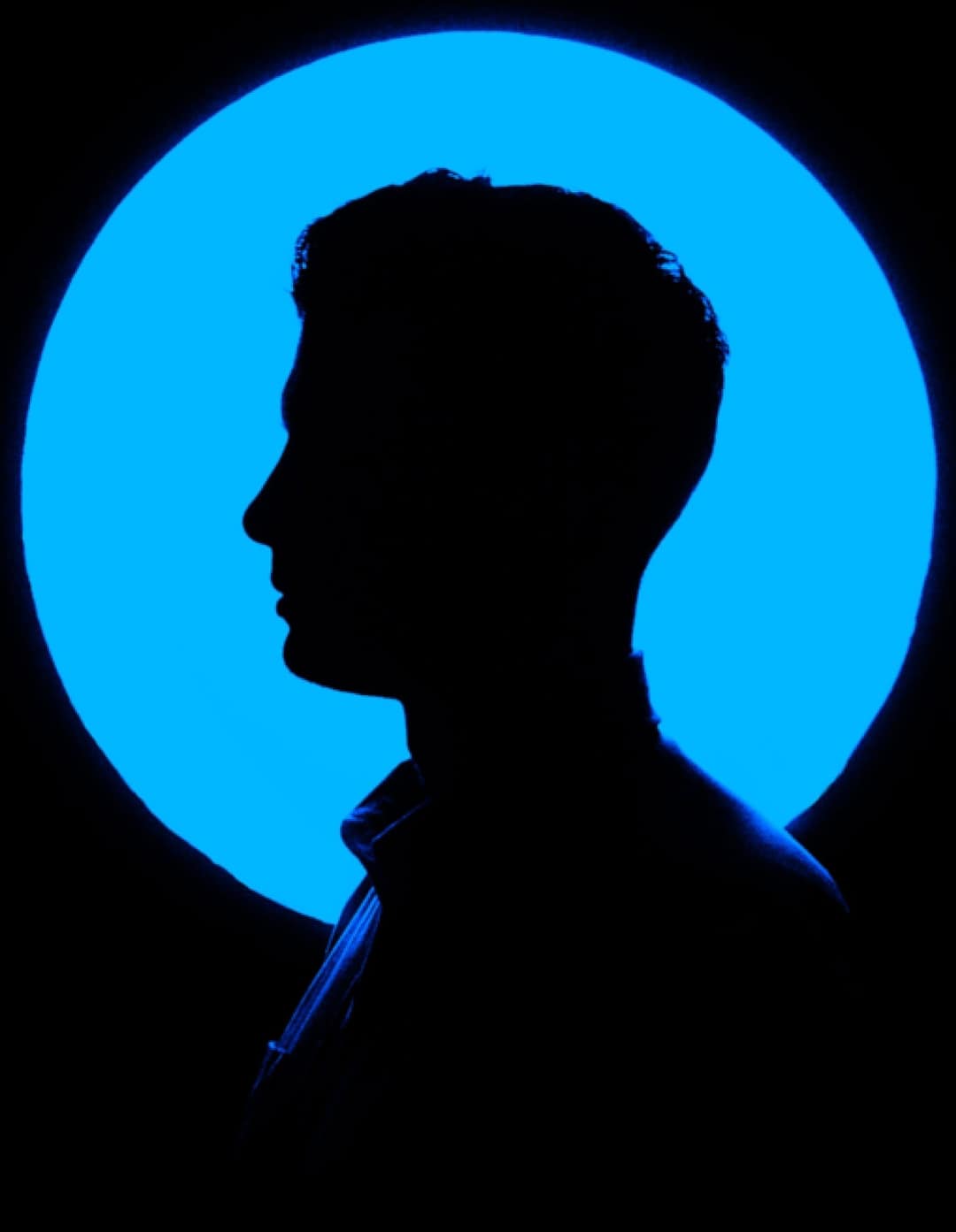 silhouetted man with a blue background 